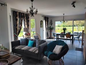 a living room with a couch and a table at Chez " Les Ligibell " in Wintzenheim