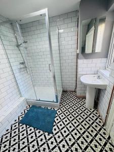 a bathroom with a shower and a sink at The Anchor in Trowbridge