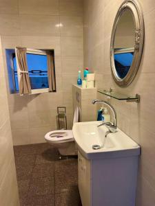 a bathroom with a sink and a toilet and a mirror at Dom na Mazurach dla kilku rodzin! Jedyny taki! HACIENDA in Radzieje