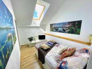 a bedroom with a bed and a tv in it at Dom na Mazurach dla kilku rodzin! Jedyny taki! HACIENDA in Radzieje