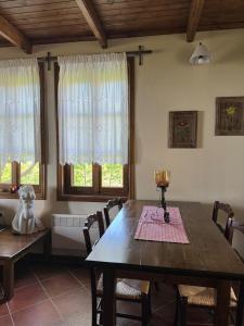 a dining room with a wooden table and chairs at Matias Kastanies Appartements with privat parking in Rachonio +15 photos