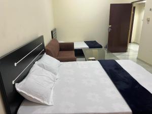 a hotel room with two beds and a couch at Blissful family room in Sharjah