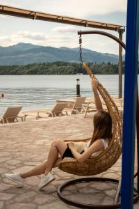 a woman sitting in a hammock on a boat at Apart-hotel Villa Lav in Tivat