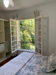 a bedroom with a bed and a large window at Hotel e Spa Provençal in Canela