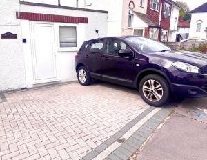 a black car parked in front of a house at Timex Studio in Croydon