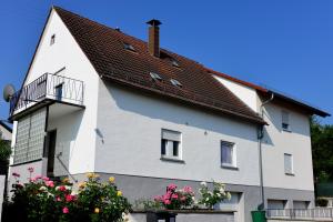 a white house with a brown roof at Gästehaus Reither in Schweigen-Rechtenbach