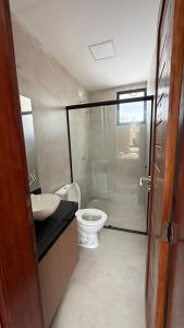 a bathroom with a toilet and a sink and a shower at Casa cocais Atins in Barreirinhas