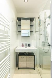 a bathroom with a sink and a shower at YOUNG VIENNA by JR City Apartments in Vienna
