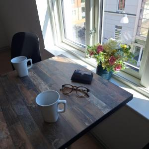 a wooden table with two cups and glasses on it at Princessen på ærten in Odense