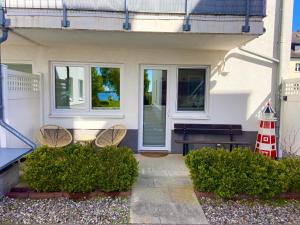 a house with two chairs and a table and a lighthouse at Susi's Seeblick in Waren