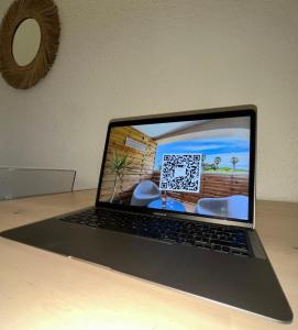 a laptop computer sitting on top of a table at La Cigale Varoise - Hyères La Plage in Hyères