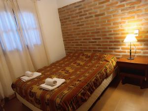 Una cama o camas en una habitación de Qurpachana