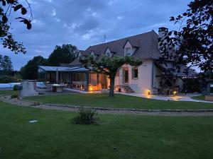 a house with a tree in the front yard at Le Refuge de Bourgogne in Poisson