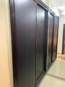 a row of black elevator doors in a room at Ecrin Moderne Islan a Agadir in Agadir