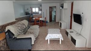 a living room with a couch and a table at Casa Elviras in Alcossebre