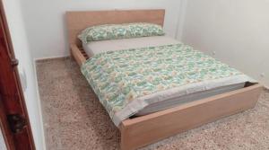 a small bed in a bedroom with a wooden frame at Casa Elviras in Alcossebre +12 photos