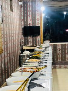 a long buffet line with plates of food on it at Wadi Rum Bedouin style camp in Wadi Rum +77 photos