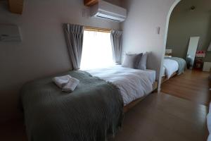 Postel nebo postele na pokoji v ubytování LugStay Retreat 琵琶湖