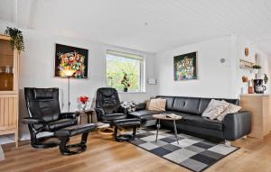 a living room with a couch and two chairs at Holiday Home Diernæs Strandby L-675 in Haderslev