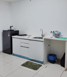 a kitchen with a sink and a refrigerator at Trefoil in Setia Alam