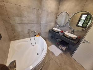 a bathroom with a large tub and two mirrors at Furnished studio for rent in city in Dakar +26 photos