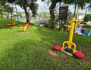 a group of colorful playground equipment in the grass at Ecuabook Via a la Costa Gye Puerto Azul in Guayaquil
