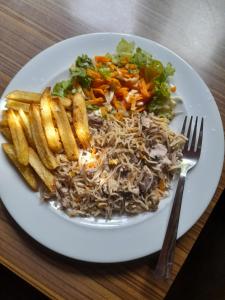 a plate of food with noodles and french fries at New Born Restaurant & Accommodation in Hikkaduwa +6 photos