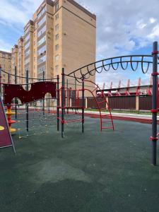 an empty playground with a slide in a city at Арман комфорт in Aktobe