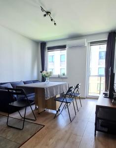 a living room with a table and chairs at Apartament "Cztery Pory Roku" in Świdnik