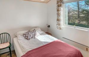 a small bedroom with a bed and a window at 3 Bedroom Beautiful Home In Hørve in Hørve