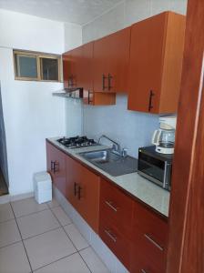 a small kitchen with a sink and a stove at Habitación en Condominio frente al mar Nuevo Vallarta in Nuevo Vallarta 