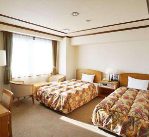 Postel nebo postele na pokoji v ubytování 寝屋川トレンドホテル