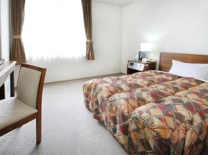 Postel nebo postele na pokoji v ubytování 寝屋川トレンドホテル