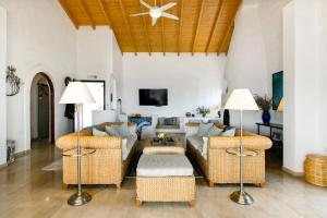 a living room with a couch and chairs at Spartilas Villas in Pyrgi