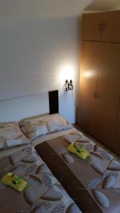 a bedroom with a bed with two pillows on it at Holiday Home White House in Sumartin