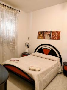 a bedroom with a bed with two towels on it at A Za' Nella Avola in Avola