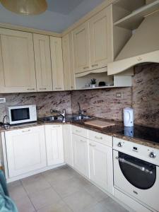 a kitchen with white cabinets and a sink at La Mansardina in Menaggio