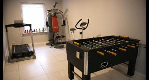 a room with a foosball table in a gym at Marina Jacht Szałkowo in Szałkowo