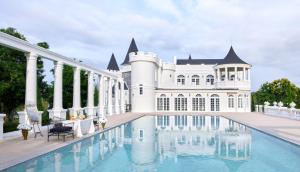 an exterior view of a mansion with a swimming pool at CastellStay in Campson