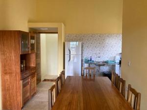 a kitchen with a dining table and a refrigerator at Jeri Cottage in Jericoacoara