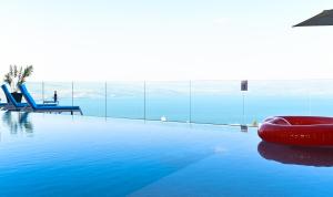 a swimming pool with a red ball on the water at Villa Selavi Private Infinity Pool - Heated Pool Additional Cost in Tiberias