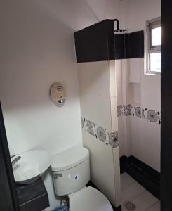 a bathroom with a toilet and a sink and a shower at Hotel Sharidia Inn in Veracruz +13 photos