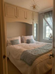 a bedroom with a large bed with a canopy at Modern Regency Townhouse London in London