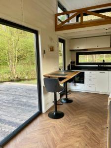 a kitchen with a desk in a tiny house at Tiny Silent House River in Zblewo