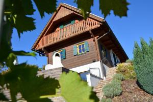 a small house with a wooden roof at Kröll-Hube in Sankt Johann im Saggautal