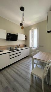 a kitchen with a table and a dining room at Residenza Stardust Suite with Canal View in Venice