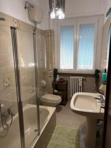 a bathroom with a shower and a toilet and a sink at Livorno Life in Livorno