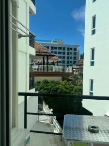 a balcony with a table and a view of a building at Maya Residence in Pattaya South