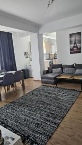 a living room with a couch and a rug at Doxa Airport Otopeni in Otopeni