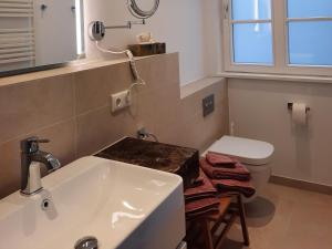 a bathroom with a sink and a toilet at Seeapartment Wustrau in Wustrau +16 photos